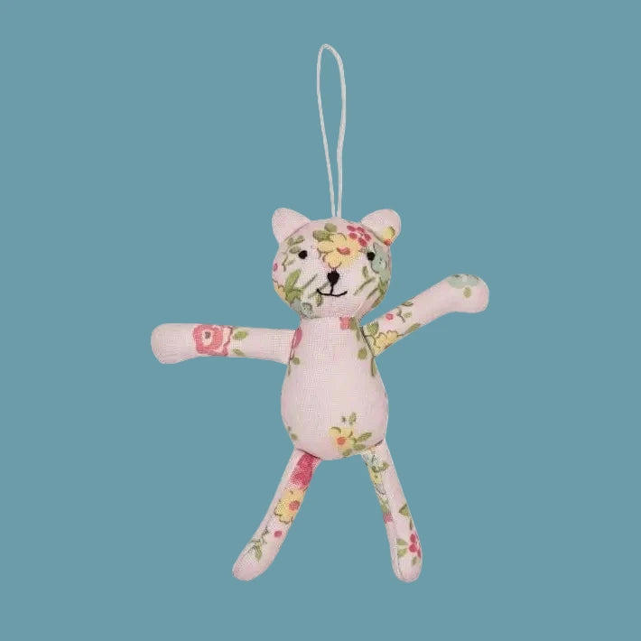 Floral-patterned stuffed animal toy on a white background