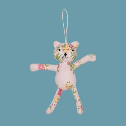 Floral-patterned stuffed animal toy on a white background